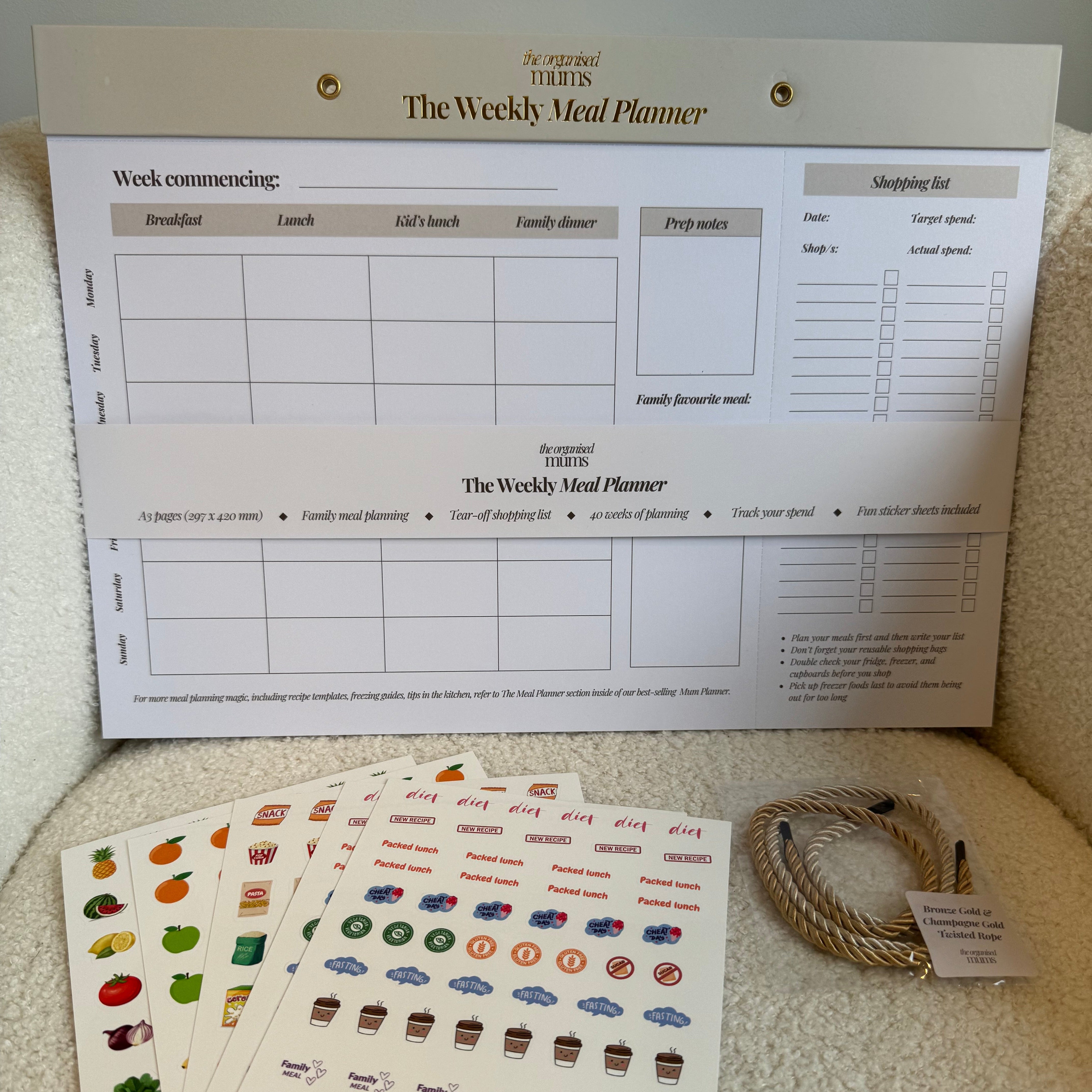 Weekly meal planner with printed stickers on a textured surface